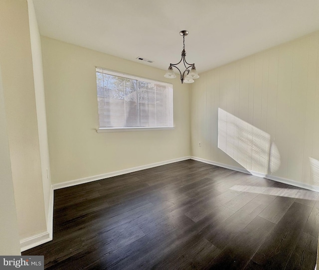 unfurnished dining area with a chandelier, visible vents, baseboards, and dark wood-style flooring