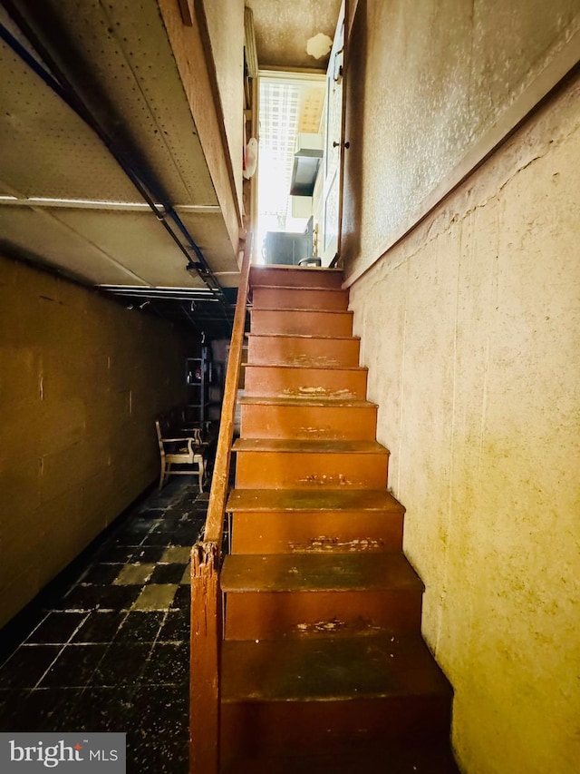 stairs featuring tile patterned floors