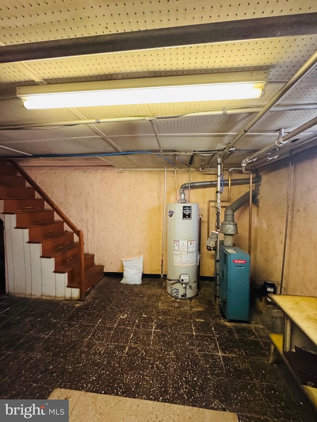 unfinished below grade area with a heating unit, water heater, and stairway