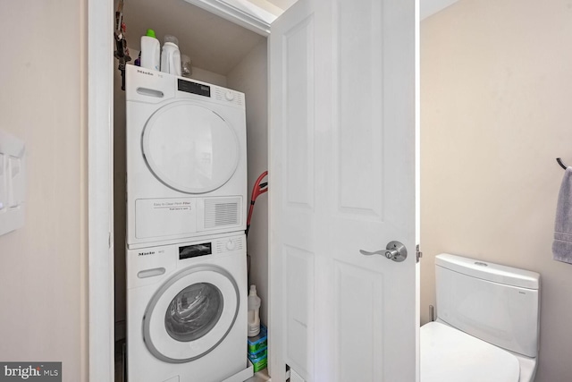 laundry room with stacked washer / drying machine