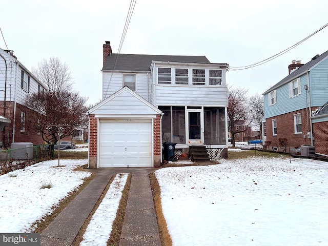 view of property featuring cooling unit, a garage, and a sunroom