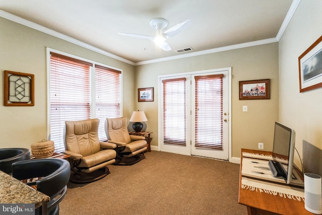 sitting room featuring carpet, visible vents, a wealth of natural light, and ornamental molding