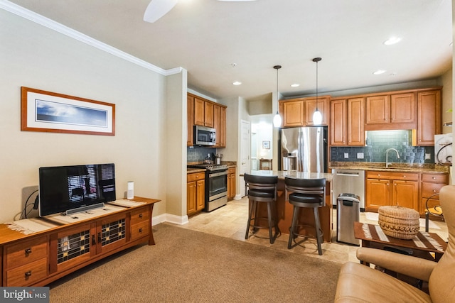 kitchen featuring light carpet, a breakfast bar area, open floor plan, stainless steel appliances, and pendant lighting