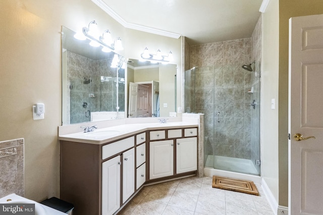 bathroom with double vanity, ornamental molding, a stall shower, and a sink