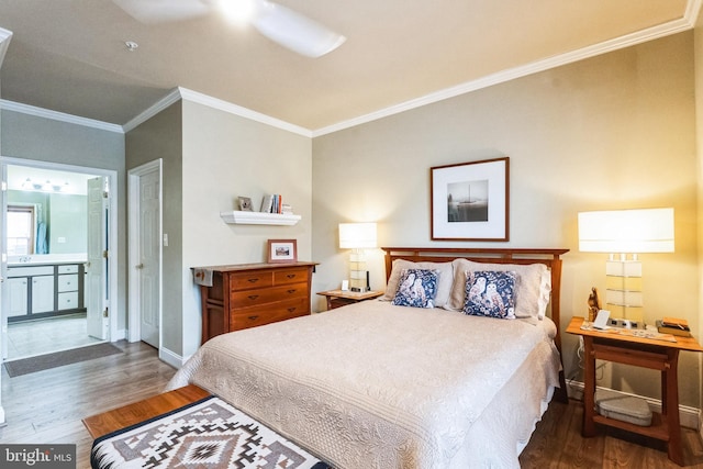 bedroom with ensuite bathroom, baseboards, wood finished floors, and crown molding