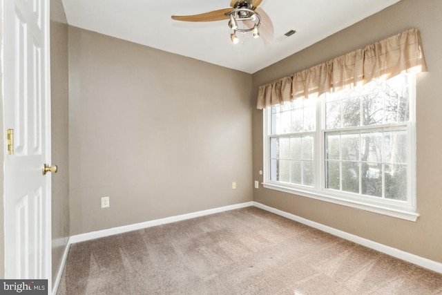 spare room featuring ceiling fan and carpet flooring