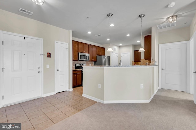 kitchen featuring appliances with stainless steel finishes, sink, light tile patterned floors, backsplash, and pendant lighting