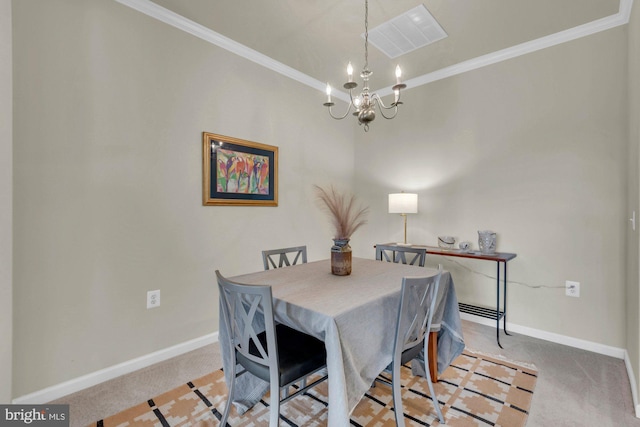 dining room with a chandelier, light colored carpet, and ornamental molding