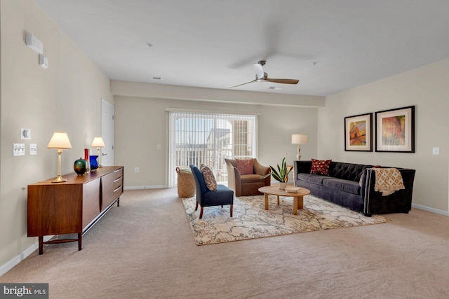 living room featuring ceiling fan and light colored carpet