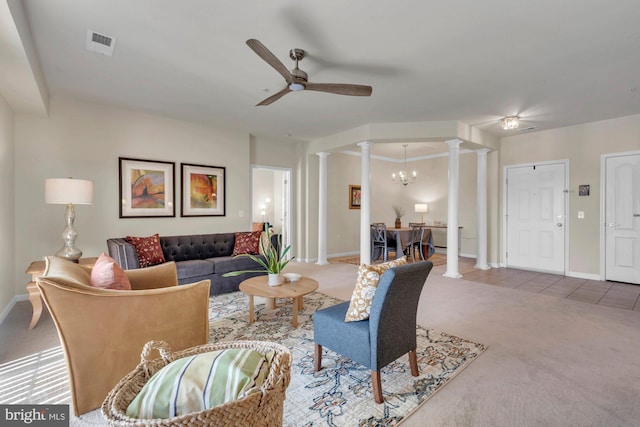 living room featuring carpet, ornate columns, and ceiling fan with notable chandelier