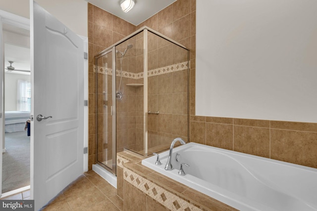 bathroom featuring tile patterned floors and separate shower and tub