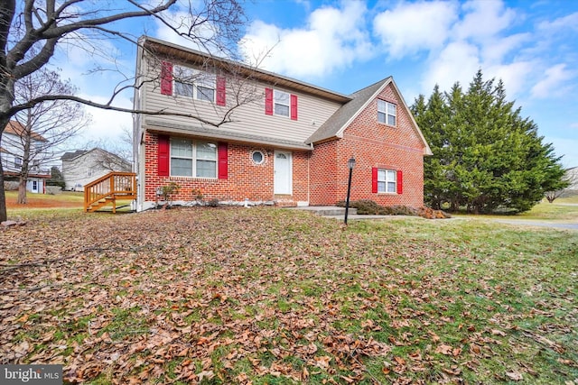 view of front of property with brick siding and a front lawn