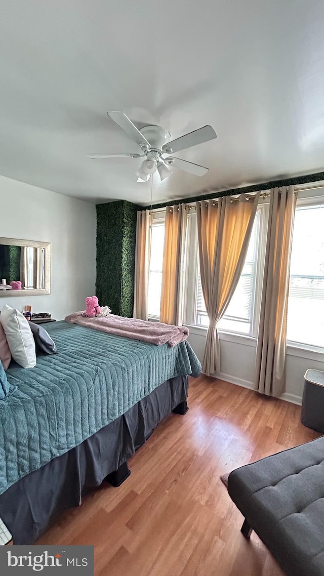 bedroom with hardwood / wood-style flooring and ceiling fan