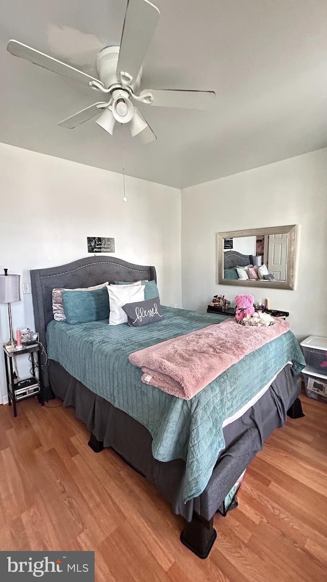 bedroom featuring hardwood / wood-style floors and ceiling fan