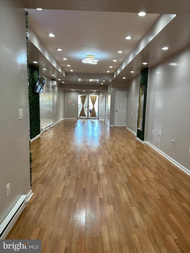 interior space with baseboard heating and wood-type flooring