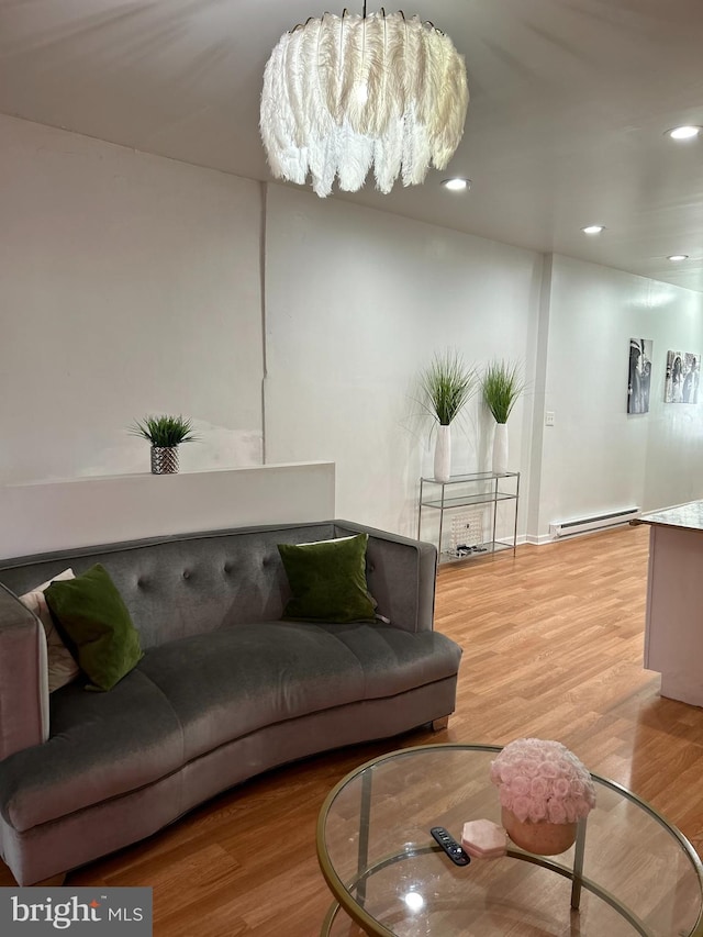 living room featuring hardwood / wood-style flooring and a baseboard heating unit