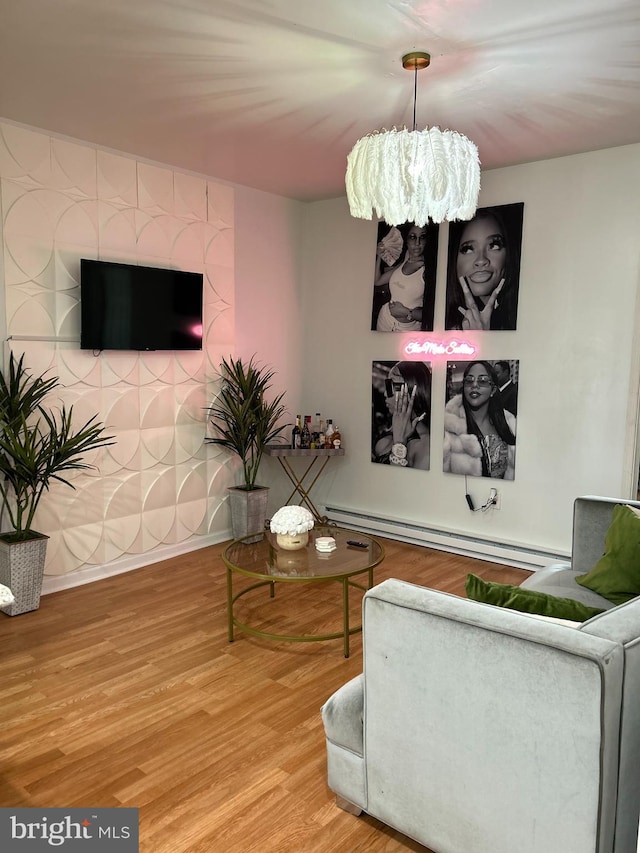 living room with a baseboard heating unit, a notable chandelier, and wood-type flooring