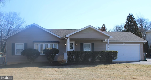 single story home with a garage, a front yard, and a shingled roof