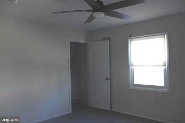 unfurnished bedroom with multiple windows, visible vents, and baseboards