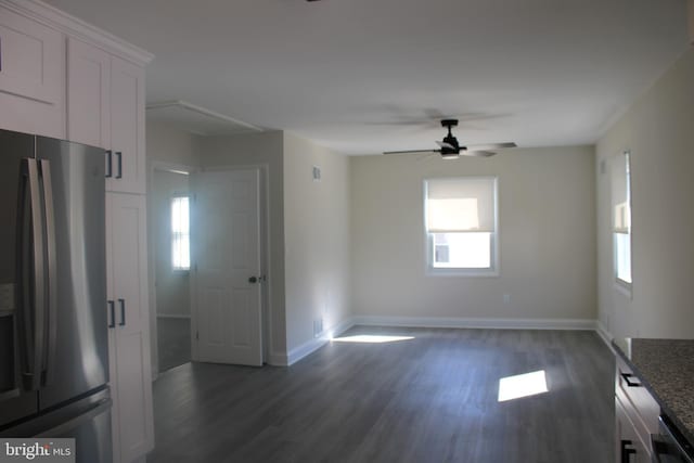 interior space featuring baseboards, dark wood finished floors, and a ceiling fan