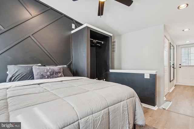 bedroom with light hardwood / wood-style floors and ceiling fan