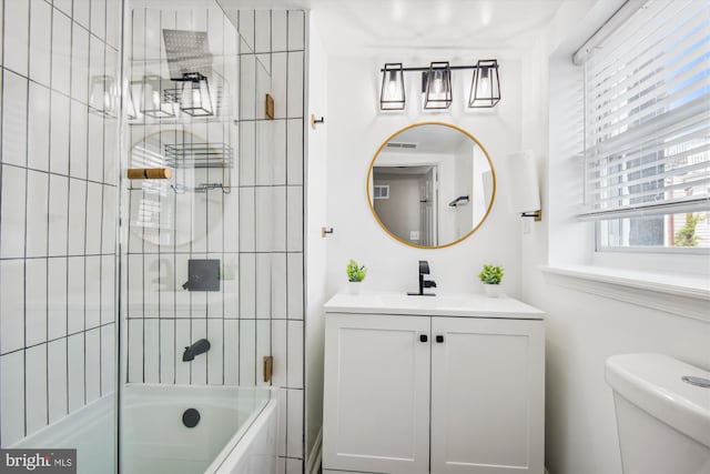 full bathroom with vanity, shower / bath combination with glass door, and toilet