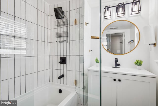 bathroom featuring vanity and tiled shower / bath combo