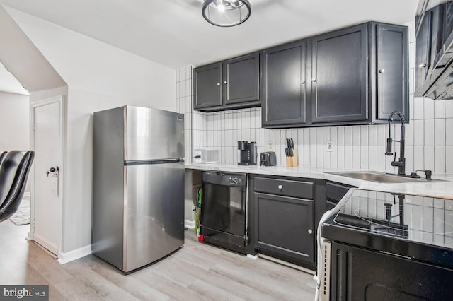 kitchen with sink, stainless steel refrigerator, dishwasher, electric range oven, and decorative backsplash