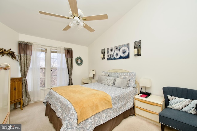 carpeted bedroom with vaulted ceiling and ceiling fan