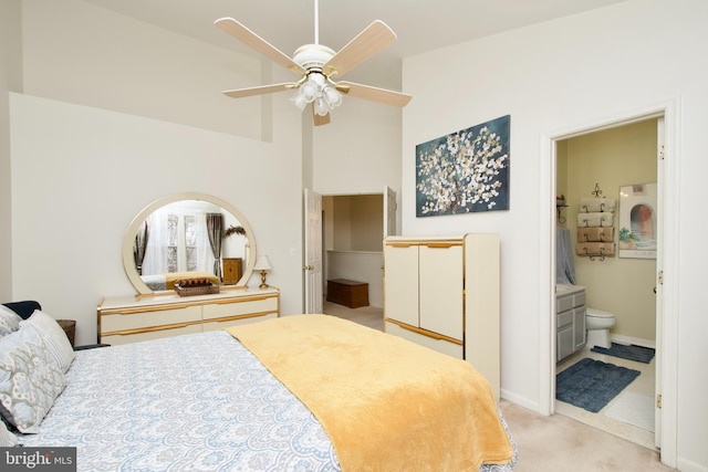 bedroom featuring high vaulted ceiling, connected bathroom, light carpet, a ceiling fan, and baseboards