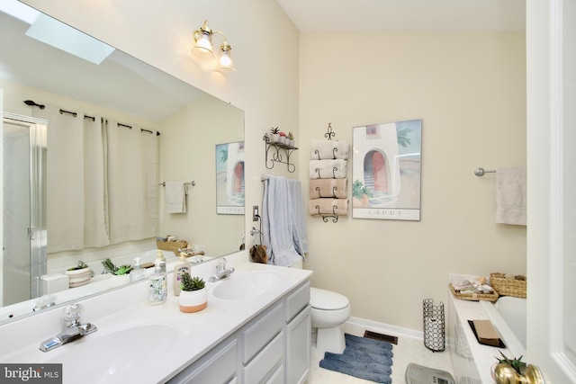 bathroom with a skylight, visible vents, a sink, and a garden tub