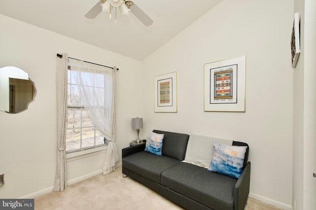 living area featuring lofted ceiling, baseboards, carpet floors, and ceiling fan