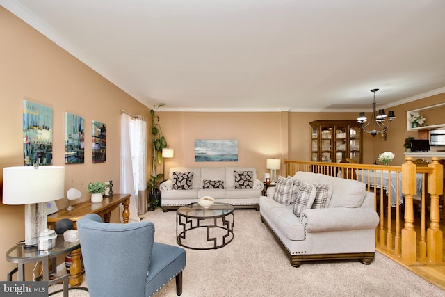 living area featuring ornamental molding, carpet, and an inviting chandelier