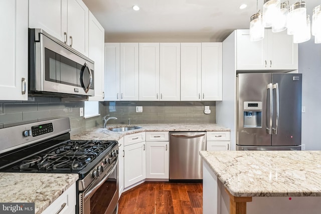 kitchen with white cabinetry, appliances with stainless steel finishes, dark wood-type flooring, and a sink