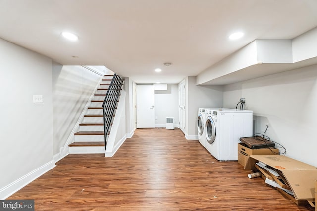 clothes washing area featuring recessed lighting, laundry area, independent washer and dryer, and wood finished floors