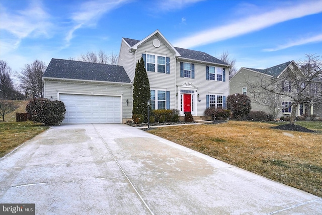 view of front facade with a garage, concrete driveway, and a front yard