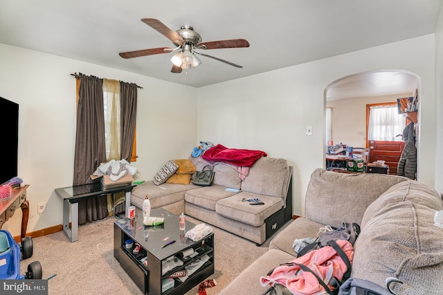 living room with light colored carpet and ceiling fan