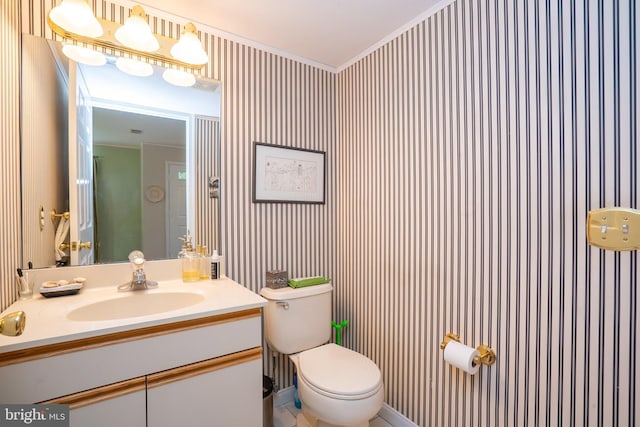 half bathroom with ornamental molding, toilet, and vanity