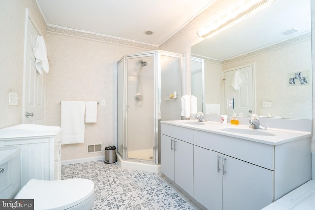 full bathroom with a stall shower, double vanity, crown molding, toilet, and baseboards