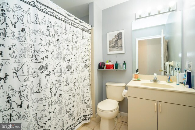 bathroom featuring toilet, tile patterned floors, vanity, and a shower with curtain