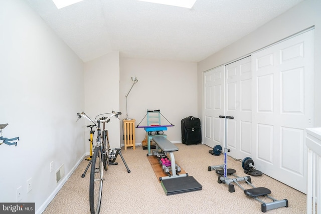 exercise area featuring carpet and baseboards