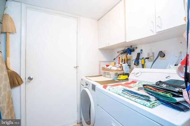 laundry room featuring washer and dryer and cabinet space