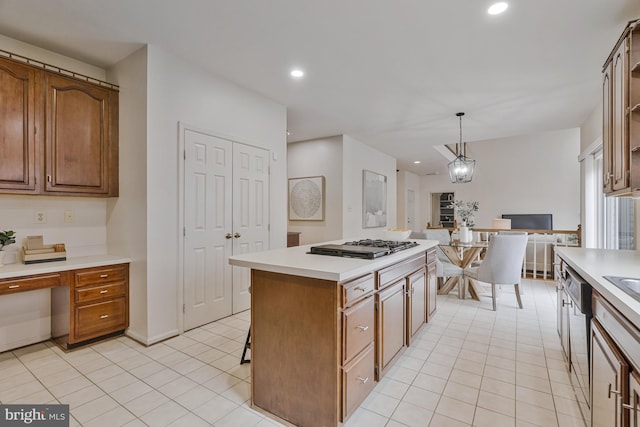 kitchen with light tile patterned floors, light countertops, appliances with stainless steel finishes, recessed lighting, and a kitchen island