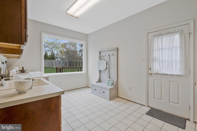 interior space featuring light countertops, a wealth of natural light, and light tile patterned flooring