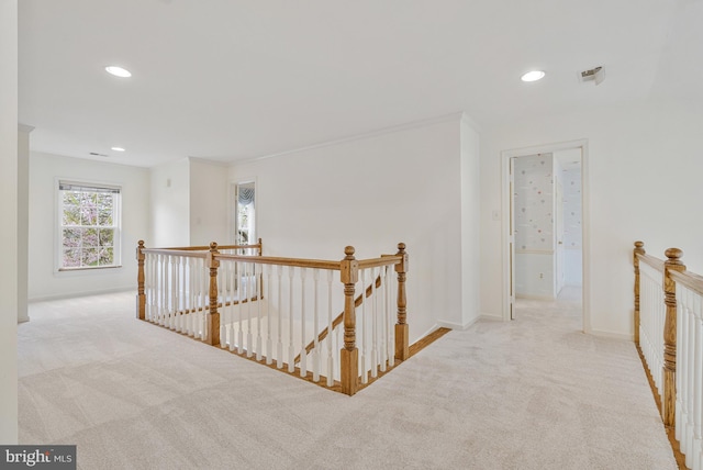 corridor with baseboards, an upstairs landing, carpet, and recessed lighting