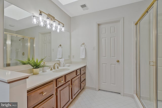 bathroom featuring visible vents, baseboards, vanity, tile patterned floors, and a stall shower