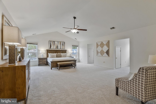 bedroom with visible vents, light colored carpet, and vaulted ceiling