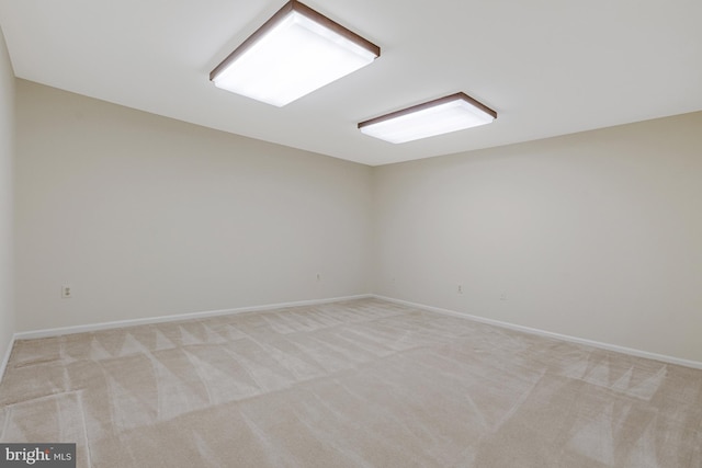 empty room with light carpet and baseboards