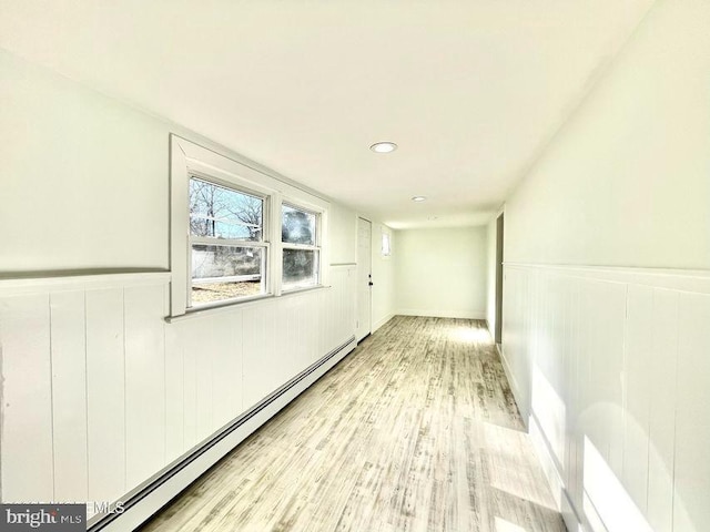 hall featuring light wood-type flooring and a baseboard radiator