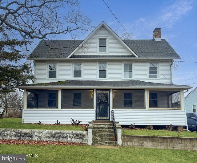 view of front of house with covered porch and a front yard